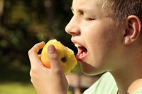 Student taking a bite out of an apple